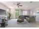 Bright living room featuring a comfortable sectional sofa, stylish coffee table, and walk-out access to a balcony at 2090 S Dorsey Ln # 1020, Tempe, AZ 85282