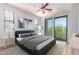 Stylized main bedroom features a large bed, bright walls, walk-out access to a balcony, and carpet floors at 2090 S Dorsey Ln # 1020, Tempe, AZ 85282