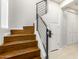Modern wood staircase featuring black metal railings, leading to upper floors in a well-lit space at 2090 S Dorsey Ln # 1020, Tempe, AZ 85282