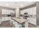 Contemporary kitchen featuring a large island with bar seating, stainless steel appliances, and ample counter space at 21258 W Wilshire Dr, Buckeye, AZ 85396