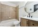 Modern bathroom with tile shower and flooring, modern vanity, and contemporary finishes at 2138 W Beaubien Dr, Phoenix, AZ 85027