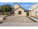 Charming single-story home featuring a well-maintained exterior with black trim windows, complemented by a low maintenance yard at 2138 W Beaubien Dr, Phoenix, AZ 85027