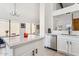 Bright kitchen featuring white cabinetry, stainless steel appliances, and a center island with seating at 2138 W Beaubien Dr, Phoenix, AZ 85027