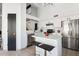 Modern kitchen featuring white cabinetry, stainless steel appliances, and a center island with seating at 2138 W Beaubien Dr, Phoenix, AZ 85027