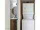 Convenient laundry area adjacent to bathroom with stacked washer and dryer at 2138 W Beaubien Dr, Phoenix, AZ 85027