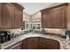 An L-shaped kitchen sink with decorative hardware, corner window, and natural light at 2165 Leisure World --, Mesa, AZ 85206