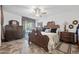 A well-lit main bedroom with ornate furniture, ceiling fan, and a sliding door at 2165 Leisure World --, Mesa, AZ 85206