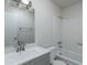 Bathroom with single sink, shower over tub with grab bar, and modern lighting at 2440 N 22Nd Ave, Phoenix, AZ 85009
