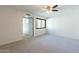 Bright bedroom with neutral walls and carpet boasts ceiling fan and an opening to another room at 2440 N 22Nd Ave, Phoenix, AZ 85009