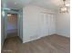 Bright bedroom featuring hardwood floors, closet doors, and stylish light fixture at 2440 N 22Nd Ave, Phoenix, AZ 85009