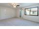 Bright bedroom with neutral tones features ceiling fan and large window offering ample natural light at 2440 N 22Nd Ave, Phoenix, AZ 85009