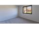 Cozy bedroom features neutral carpet and a window with an outside view at 2440 N 22Nd Ave, Phoenix, AZ 85009
