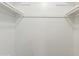 Bright walk-in closet with white walls and clothing rods for organized storage at 2440 N 22Nd Ave, Phoenix, AZ 85009