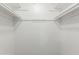 Spacious walk-in closet features white walls and shelving for ample storage at 2440 N 22Nd Ave, Phoenix, AZ 85009