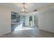 Open dining area with modern light fixture, eat-in kitchen, and sliding glass doors to the patio at 2440 N 22Nd Ave, Phoenix, AZ 85009