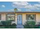 Inviting home exterior with a secure front door, lush shrubbery, and a mature palm tree accentuating its charm at 2440 N 22Nd Ave, Phoenix, AZ 85009