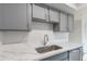 Close-up of kitchen with sleek countertops, modern sink, and updated cabinetry, designed for both style and functionality at 2440 N 22Nd Ave, Phoenix, AZ 85009