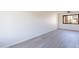 A spacious living room is enhanced by the contemporary flooring, neutral color palette, and large, bright windows at 2440 N 22Nd Ave, Phoenix, AZ 85009