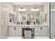 Luxurious primary bathroom featuring dual vanities, elegant mirrors, and a make-up vanity at 26217 N 19Th Ln, Phoenix, AZ 85085