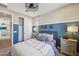 Comfortable bedroom featuring two-tone walls, a modern ceiling fan, and a closet with sliding doors at 26217 N 19Th Ln, Phoenix, AZ 85085