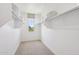 Walk-in closet featuring carpet flooring, a window for natural light, and ample shelving and rod space at 26217 N 19Th Ln, Phoenix, AZ 85085