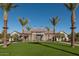 Beautiful community center framed by palm trees on a sunny day with green grass at 26217 N 19Th Ln, Phoenix, AZ 85085