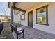 Welcoming front porch with a bench, covered entryway, dark trim, and charming accents at 26217 N 19Th Ln, Phoenix, AZ 85085