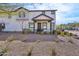 Inviting two-story home with a covered front porch, black trim, and drought-tolerant landscaping at 26217 N 19Th Ln, Phoenix, AZ 85085