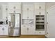 Kitchen showcases stainless steel refrigerator and double ovens, complemented by white cabinetry at 26217 N 19Th Ln, Phoenix, AZ 85085