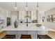 Stylish kitchen island with modern pendant lighting, stainless appliances and ample counter space at 26217 N 19Th Ln, Phoenix, AZ 85085