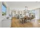 Open-concept kitchen and dining area with modern lighting, stainless steel appliances, and ample seating at 26217 N 19Th Ln, Phoenix, AZ 85085