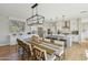 Well-lit kitchen and dining area with white cabinetry, stainless steel appliances, and modern fixtures at 26217 N 19Th Ln, Phoenix, AZ 85085