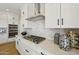 Well-equipped kitchen features a modern gas cooktop, white cabinets, and stylish backsplash at 26217 N 19Th Ln, Phoenix, AZ 85085