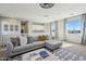 Cozy living space with sectional sofa, plush ottoman, and large windows providing ample natural light at 26217 N 19Th Ln, Phoenix, AZ 85085