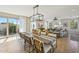 Spacious dining and living area with large windows, stylish furniture, and plenty of natural light at 26217 N 19Th Ln, Phoenix, AZ 85085