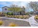 A street view of a two-story home with desert landscaping, trees, and a sidewalk at 26217 N 19Th Ln, Phoenix, AZ 85085