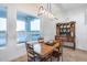 Cozy dining room features a large window with desert views and rustic furnishings perfect for entertaining at 28211 N Quintana Pl, Queen Creek, AZ 85144