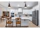 Modern kitchen with white cabinetry, a large island, stainless steel appliances, and stylish pendant lighting at 28211 N Quintana Pl, Queen Creek, AZ 85144