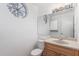 Bright bathroom featuring a round window and vanity with sink at 2875 W Highland St # 1102, Chandler, AZ 85224