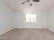 Neutral carpeted bedroom offers natural light from window and modern ceiling fan at 2875 W Highland St # 1102, Chandler, AZ 85224