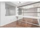 Open-concept dining area with wood floors and decorative wall mirror at 2875 W Highland St # 1102, Chandler, AZ 85224