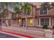 Charming townhome exterior with brick accents, large windows, and manicured landscaping at 2875 W Highland St # 1102, Chandler, AZ 85224