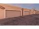Garages with neutral colors, clearly marked unit numbers, and classic architectural style at 2875 W Highland St # 1102, Chandler, AZ 85224