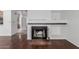 Living room featuring a cozy fireplace, hardwood floors and white shelving at 2875 W Highland St # 1102, Chandler, AZ 85224