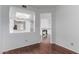 Open-concept living space with hardwood floors leading to the kitchen and fireplace at 2875 W Highland St # 1102, Chandler, AZ 85224