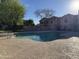 Community pool with clear blue water surrounded by a tan concrete deck and a wrought-iron fence at 2875 W Highland St # 1102, Chandler, AZ 85224