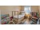 Bright bedroom with a twin bed, play area, window and wood-look flooring, creating a fun space at 2966 S Country Club Way, Tempe, AZ 85282