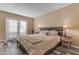 Cozy bedroom featuring a comfortable bed with a decorative headboard and sliding doors to the exterior at 2966 S Country Club Way, Tempe, AZ 85282