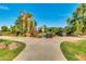 Sidewalk intersection in community park with lake view and lush vegetation on a sunny day at 2966 S Country Club Way, Tempe, AZ 85282