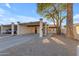 Exterior view of home with desert landscaping, covered parking, and desert tree at 2966 S Country Club Way, Tempe, AZ 85282
